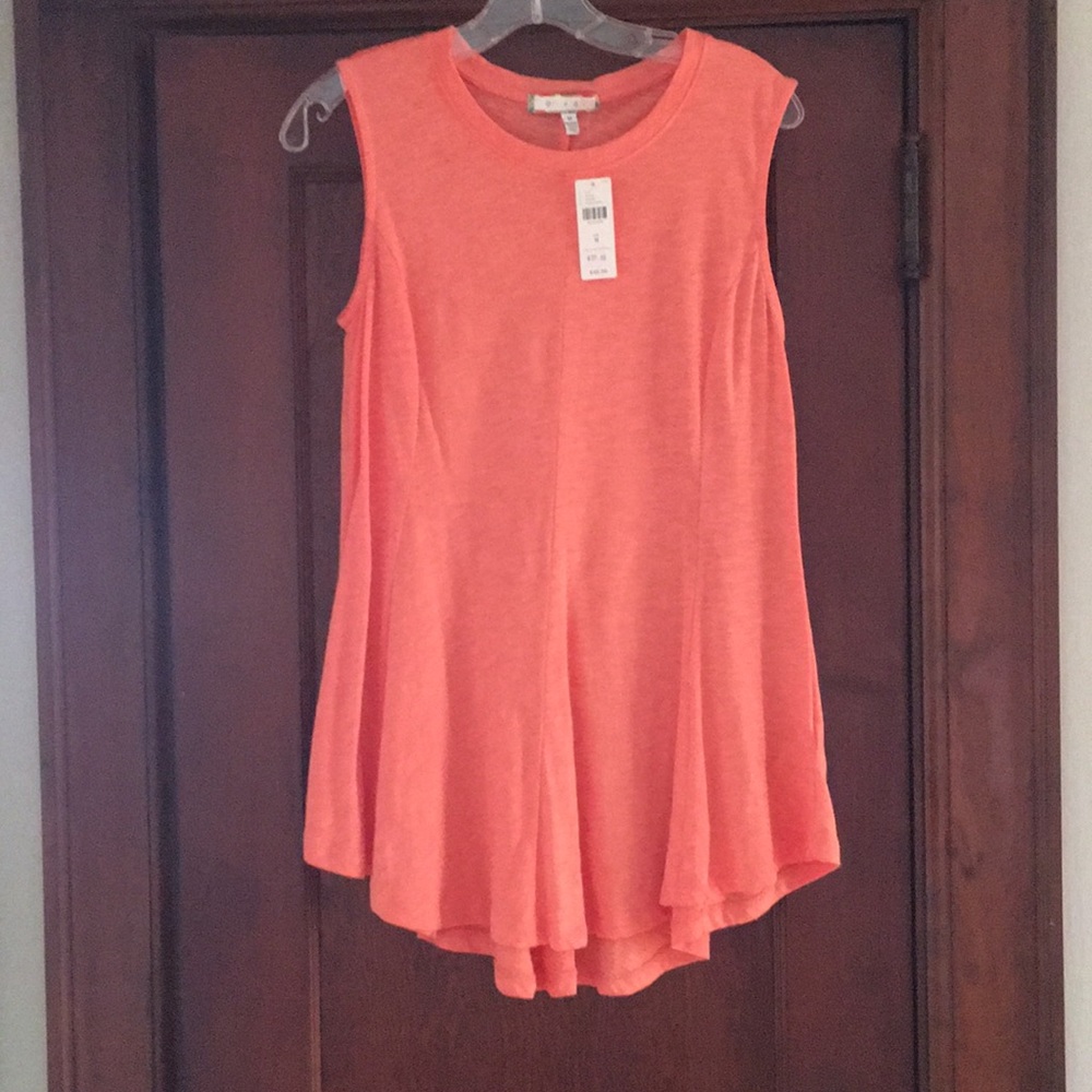 Anthropologie top in soft melon shade.